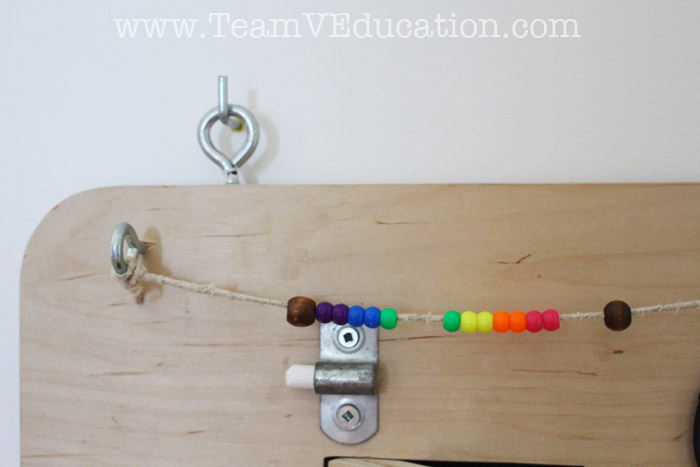 DIY Toddler Busy Board with peek-a-boo doors, latches, locks, and more!