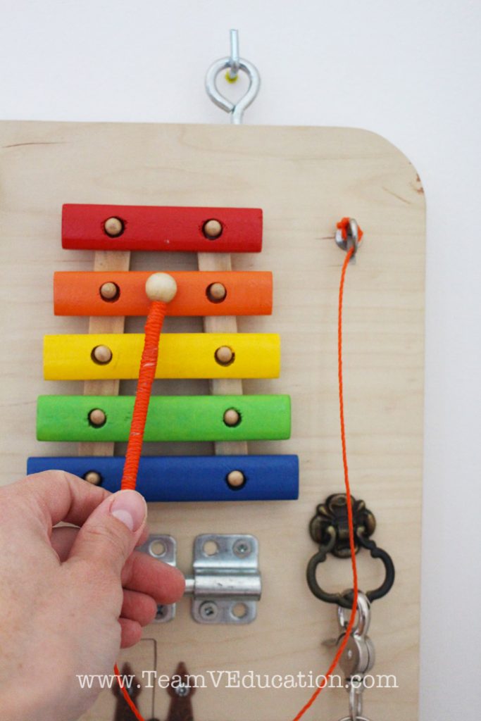 DIY Toddler Busy Board with peek-a-boo doors, latches, locks, and more!