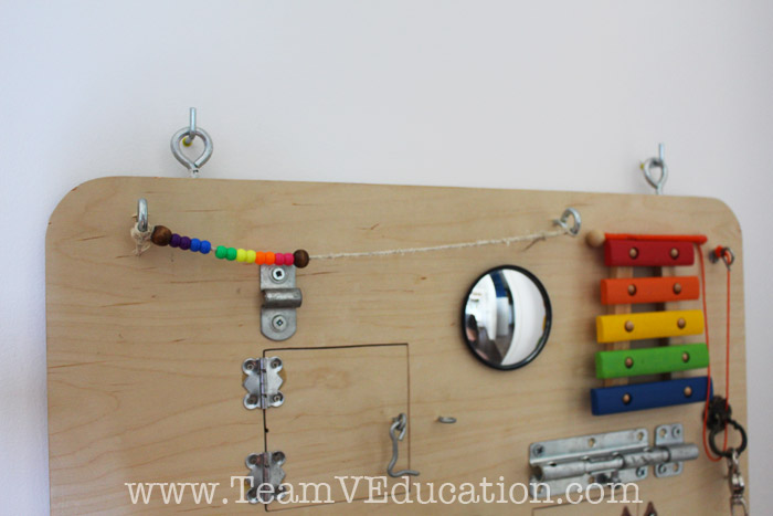 DIY Toddler Busy Board with peek-a-boo doors, latches, locks, and more!